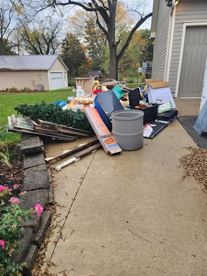 Dumpster being loaded with debris for Estate Cleanout Dumpster Rental in Whitman